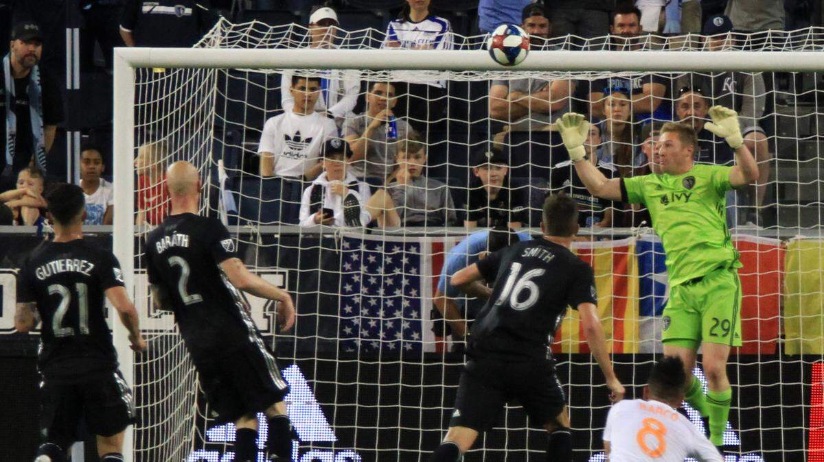 Sporting Kansas City goalkeeper Tim Melia deflects an Atlanta United shot away Sunday night at Children’s Mercy Park. The deflection fell to Josef Martinez, who scored to put Atlanta up 1-0 in the 39th minute.