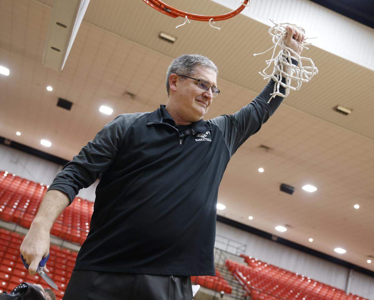 North Crowley head coach Tommy Brakel cuts down the winning net after defeating Duncanville in a UIL Class 6A Division I boys semifinal basketball game at Wilkerson-Greines Activity Center in Fort Worth, Texas, Tuesday, March 10, 2026.