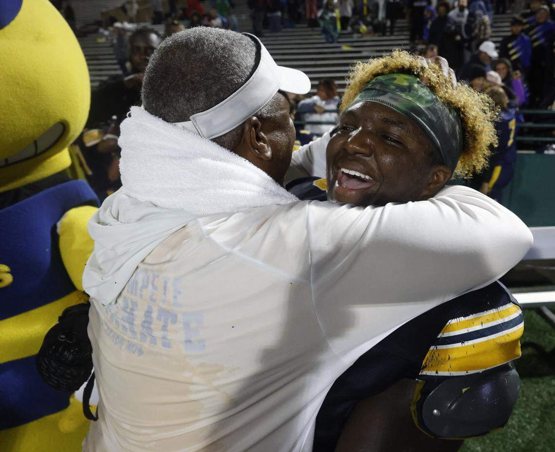 Fort Worth Arlington Heights head coach Curtis James hugs one of his sons, defensive lineman Caynan James, after a Class 5A Division I area-round playoff victory over Lubbock Monterey on Thursday at Shotwell Stadium in Abilene.