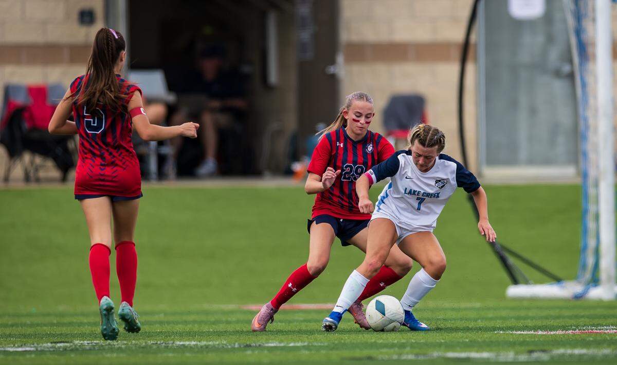 Grapevine’s Claire Jenkins (29) defends against Montgomery Lake Creek’s Hallie Montgomery (7) as Tatum Harig (5) chases in the UIL Class 5A Division II state soccer championship game on Friday, April 10, 2026, at Birkelbach Field in Georgetown, Texas.