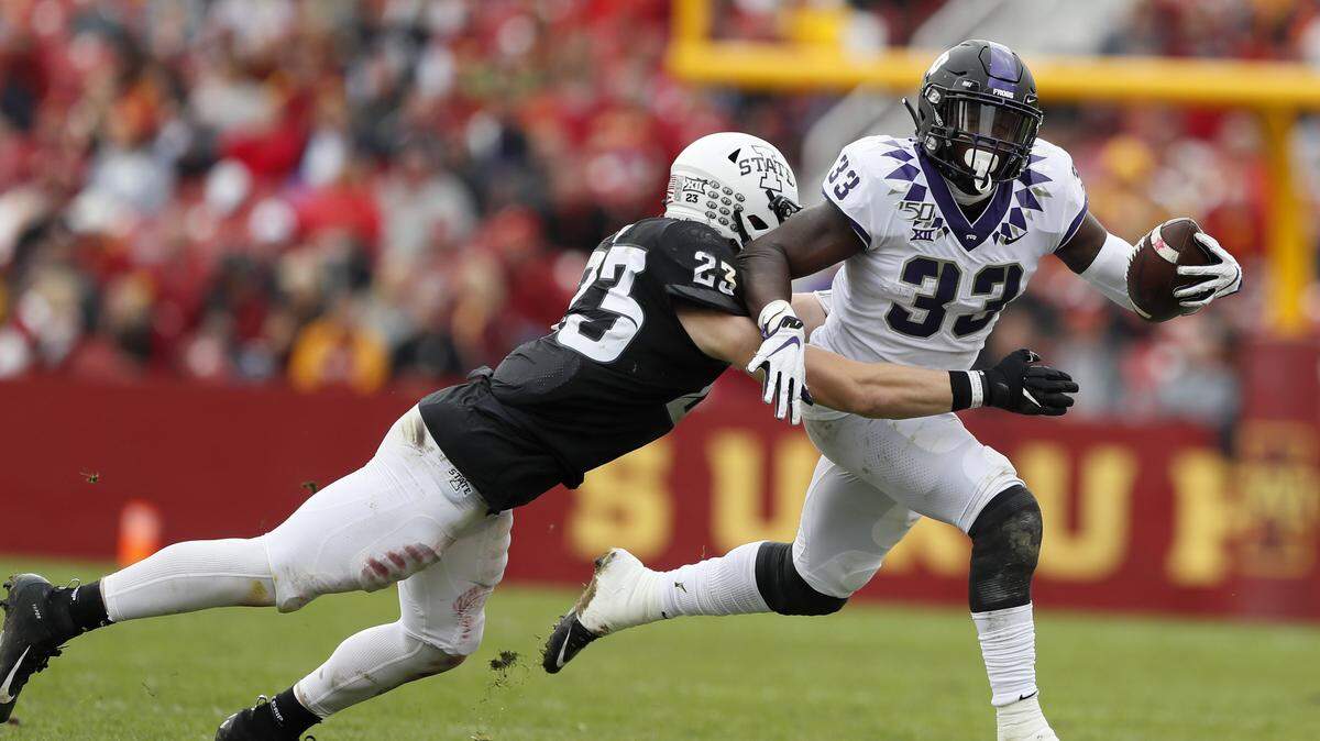 TCU running back Sewo Olonilua (33) is tackled by Iowa State linebacker Mike Rose (23) during the first half of an NCAA college football game, Saturday, Oct. 5, 2019, in Ames, Iowa. (AP Photo/Charlie Neibergall)
