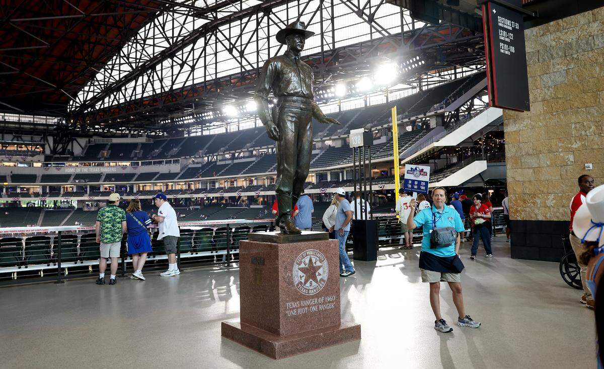 The “One Riot, One Ranger” statue stands in the main concourse of Globe Life Field on Friday before the Texas Rangers’ home opener.