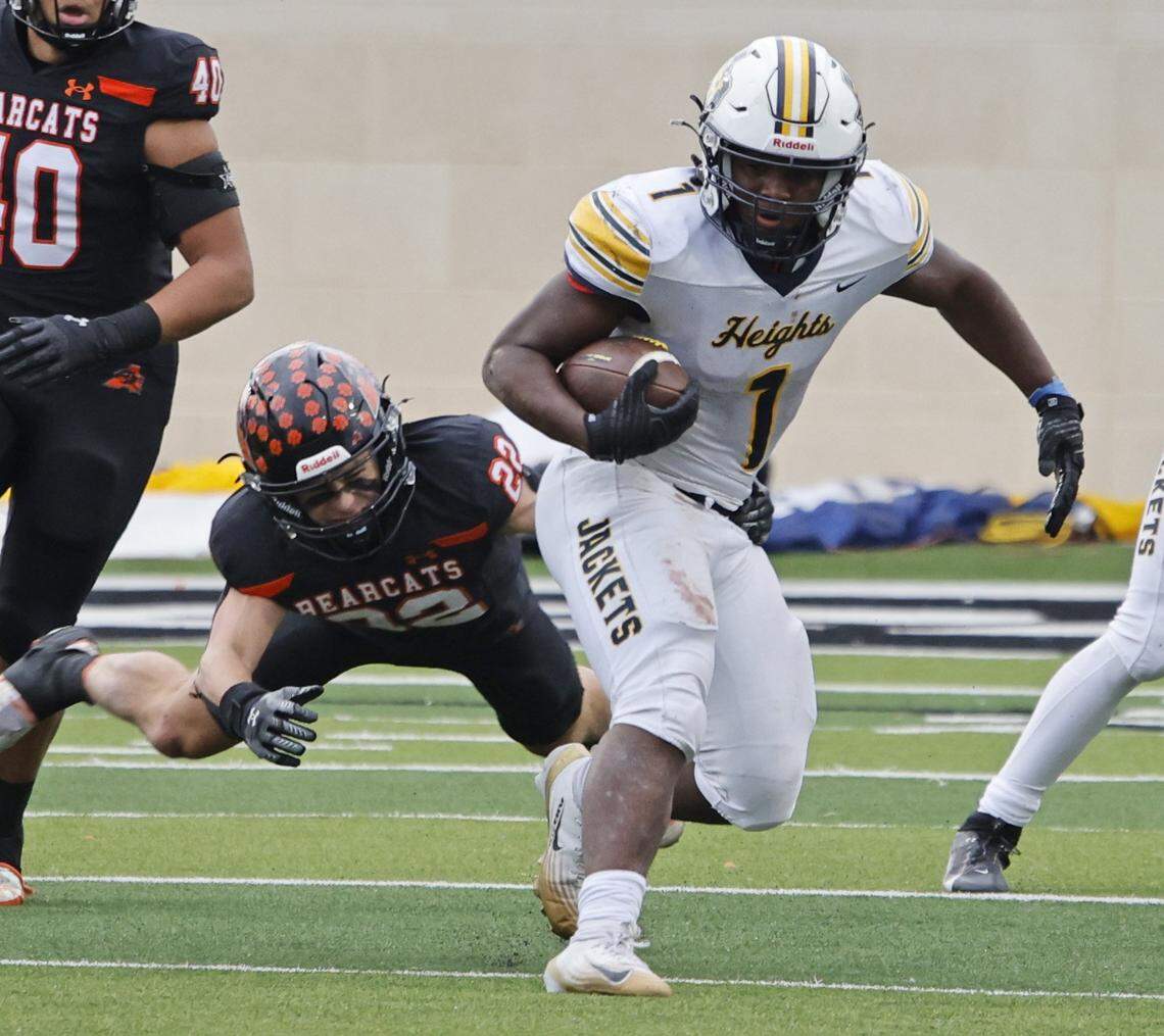 Fort Worth Arlington Heights running back Carson James (1) gains a few of his 43 yards of the a UIL Class 5A Division I Regional against Aledo on Friday Nov. 28, 2025 at Crowley ISD Multi-Purpose Stadium in Fort Worth, Texas.