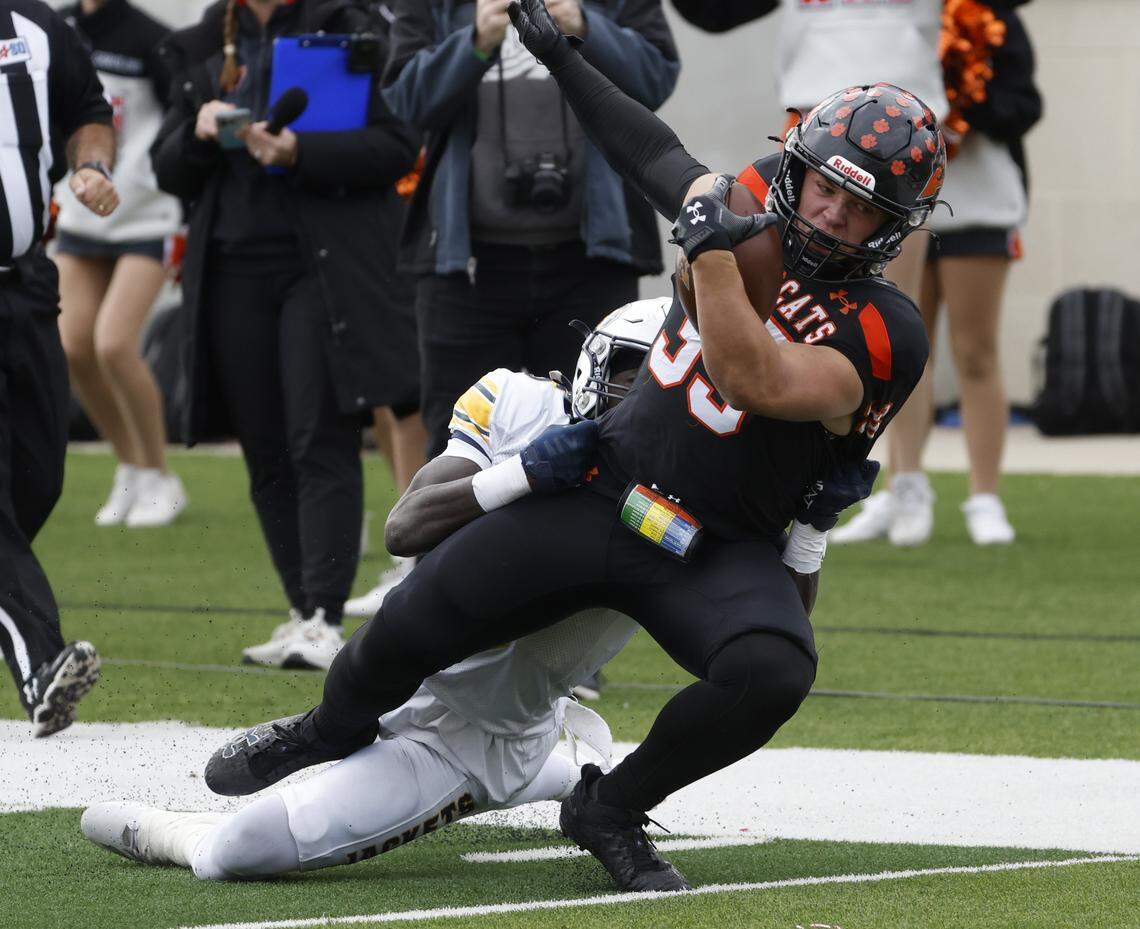 Fort Worth Arlington Heights free safety Ce'antae Johnson (6) brings down Aledo running back Brady Powell (39) after a gain during the first half of a UIL Class 5A Division I Regional on Friday Nov. 28, 2025 at Crowley ISD Multi-Purpose Stadium in Fort Worth, Texas.