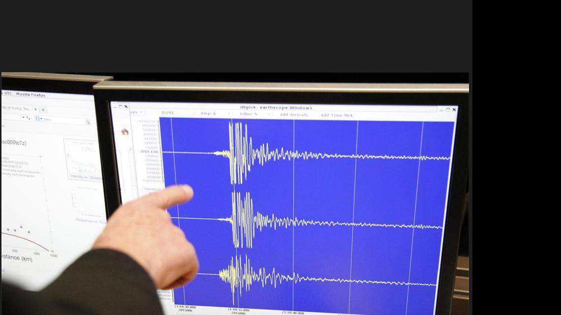 SMU professor Brian Stump points to seismograms on a screen from Irving station, deployed yesterday during a press conference at SMU on Jan. 6, 2015. 