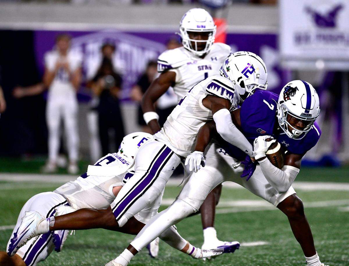 SFA cornerback Jalen Mayo tackles ACU wide receiver Javon Gipson Saturday Sept. 6, 2025. Abilene Christian University defeated Stephen F. Austin University at home, 28-20.