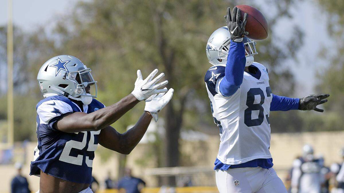Dallas Cowboys wide receiver Terrance Williams (83) makes a one-handed catch in front of defensive back Xavier Woods (25) during the afternoon practice at training camp in Oxnard, Calif., on Wednesday, Aug. 1, 2018.