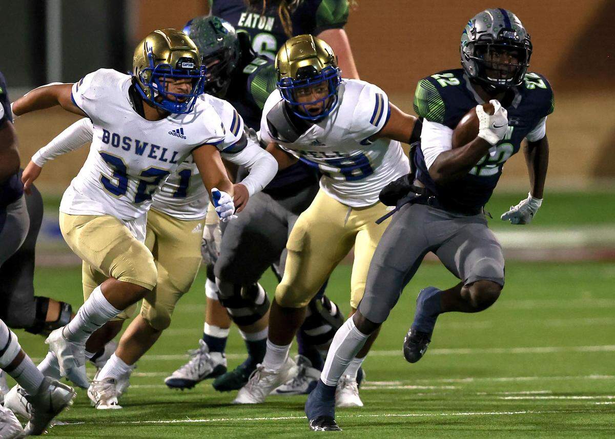 Eaton running back JB Brown (22) finds a huge hole to run and goes 66 yards for a touchdown against Fort Worth Boswell during the first half of the 6A Bi-District Region I Division II High School Football playoff game played at Northwest ISD Stadium on Thursday, November 11, 2021, in Justin. (Steve Nurenberg/Special to the Star-Telegram)