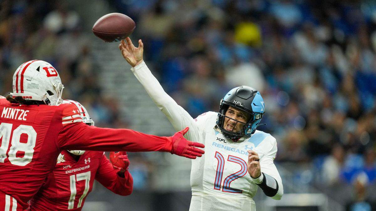 Arlington Renegades quarterback Luis Perez (12) throws a pass in front of DC Defenders defensive lineman Andre Mintze (48) on Saturday in the XFL title game. Perez was named the Most Valuable Player of the game.