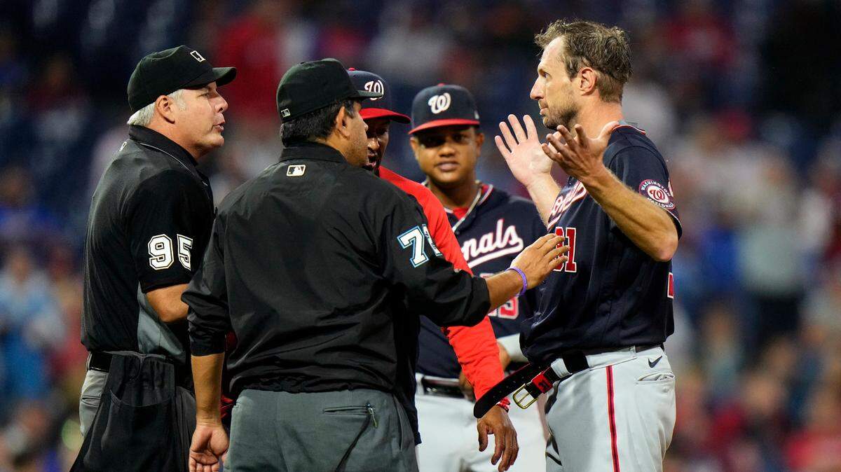Washington Nationals pitcher Max Scherzer, right, is checked for foreign substances during the middle of the fourth inning of a game against the Philadelphia Phillies Tuesday night.