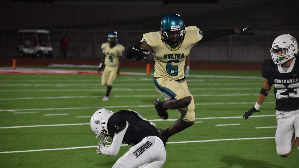 Dallas Molina’s Isaiah Thompson (6), hurdles over Fort Worth South Hills Eric Flores (6), during a high school football game at Clark Stadium in Fort Worth, Texas, Thursday, Aug. 25, 2022, Molina won 42-0 (Luke Zentner/special to the Star-Telegram)