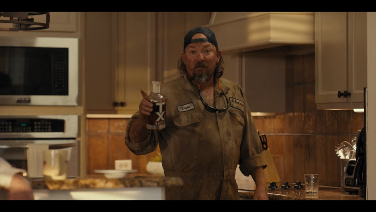 Dale (James Jordan) pours himself a glass of TX Whiskey in “Landman” episode 2.