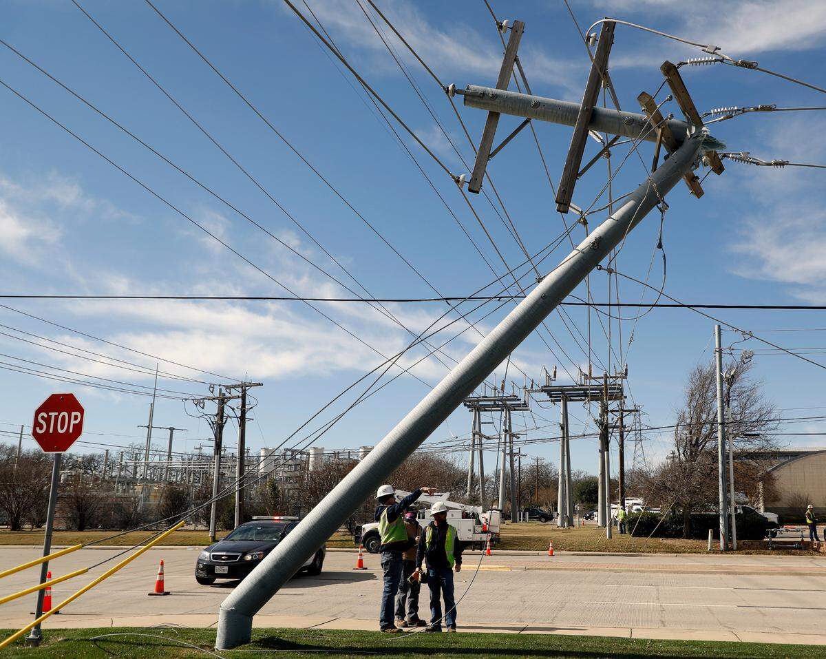 Oncor workers survey the damage at a main feeder pole that is approximately 200 yards from an accident in Hurst on Tuesday. The accident downed one pole and damaged three others along Precinct Line. The emergency power generator and switch was damaged at the fire house. It also broke water pipes and flooded the building. No one other than the driver was injured. According to two Oncor reps, power should be restored by late Tuesday night or Wednesday morning.