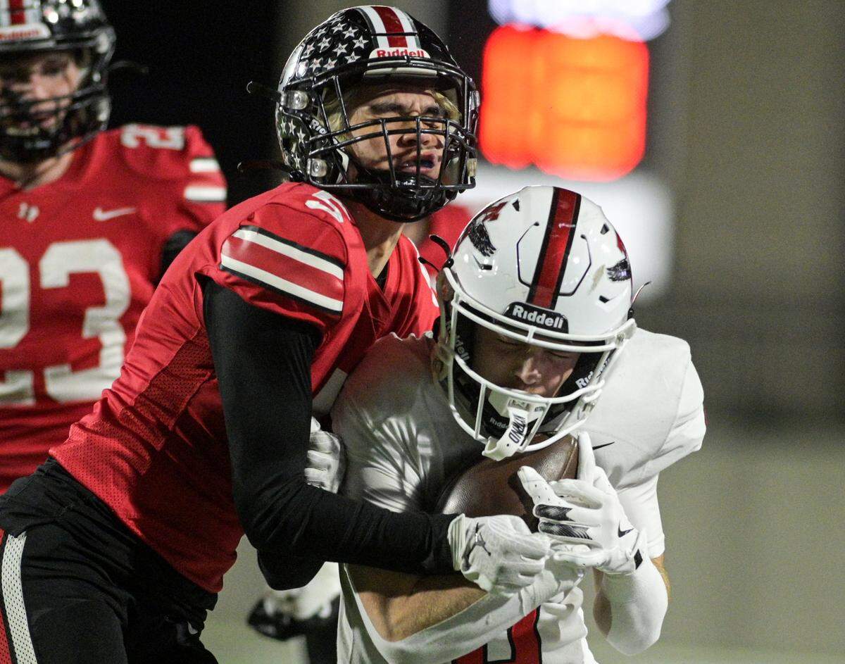 Argyle running back Watson Bell (6) protects the football bracing for a hit from Lovejoy defensive back Beyer Toyooka (5) during the Class 5A Division II Region I playoff game against Lovejoy High School at Prosper ISD Children’s Health Stadium in Prosper, Texas on Friday, Dec. 6, 2024.