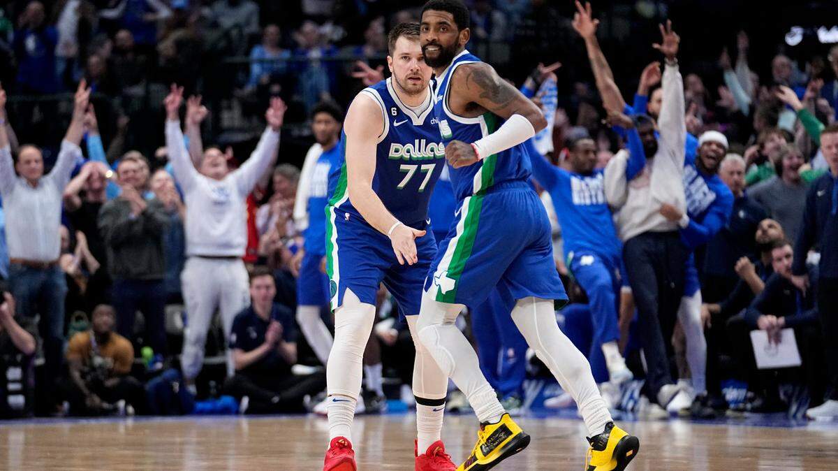 Dallas Mavericks’ Luka Doncic (77) and Kyrie Irving, right, celebrate at mid-court in the second half of an NBA basketball game against the Minnesota Timberwolves, Feb. 13, at American Airlines Center.