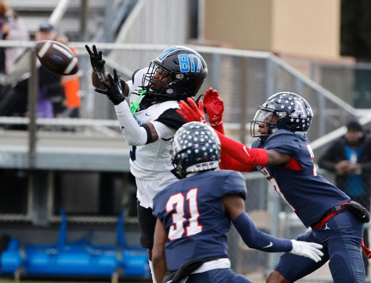 North Crowley wide receiver Dekoryian West-Davis (3) catches a touchdown pass defended by Allen defensive backs Camden Clark (31) and Henson Ameachi (27) during the first half of a UIL Conference 6A Division 1 quarterfinal football playoff game at Dragon Stadium in Southlake, Texas, Saturday, Dec. 02, 2023.