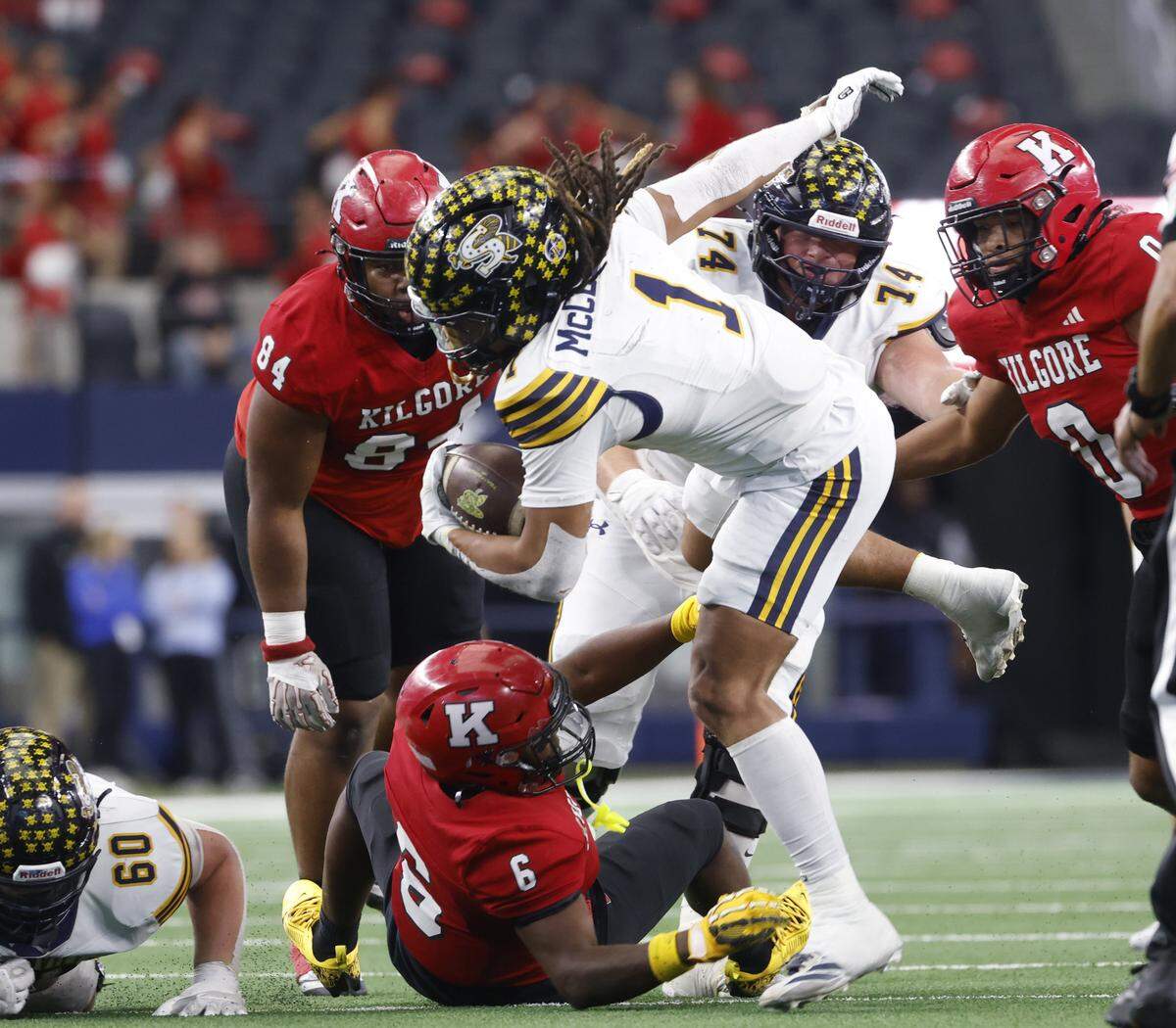 Stephenville running back Zyler McClendon (1) steps over the shoe string tackle from Kilgore linebacker David McGowan (6) during the first half of the UIL Class 4A Division I championship game on Friday Dec. 19, 2025 at AT&T Stadium in Arlington, Texas.