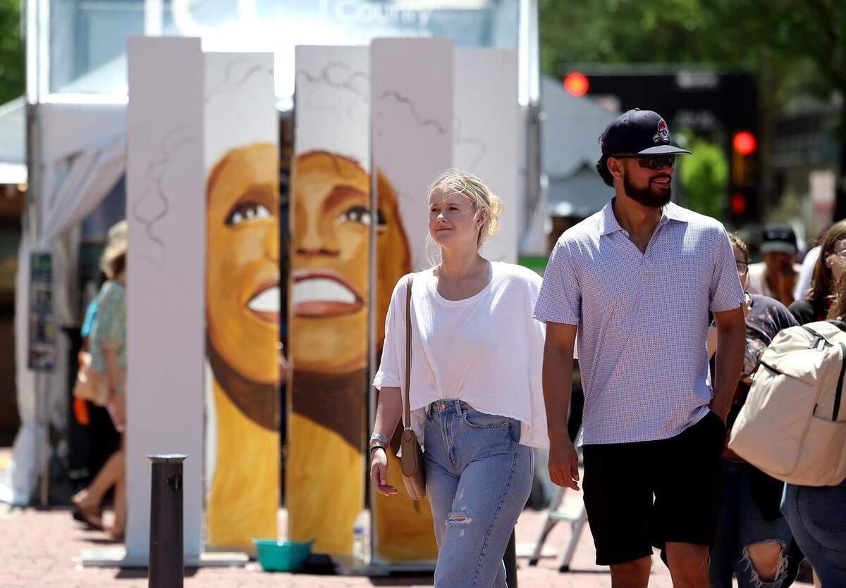 Visitors cross into Sundance Square, where the Fort Worth Art Fair features around 100 local artists, on Friday, April 21, 2023.