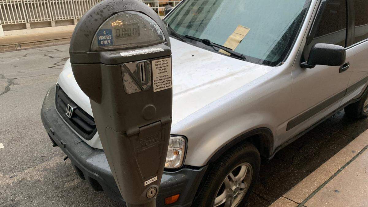 A car parked on Fifth Street in downtown Fort Worth gets a parking meter citation.