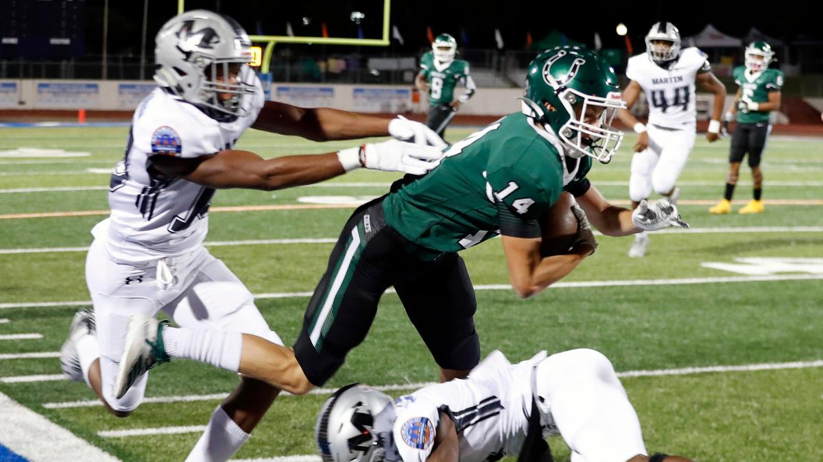Arlington receiver Eli Lemonds is brought down by Martin’s defense during the first half of a high school football game at UTA Maverick Stadium in Arlington, Texas, Friday, Oct. 18, 2019.