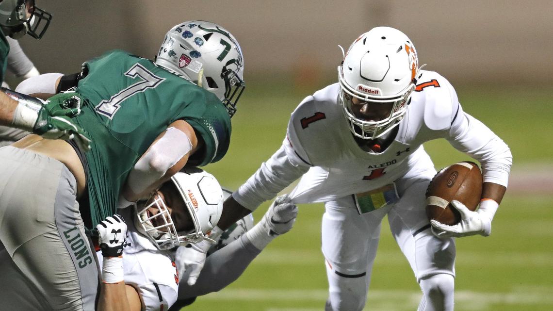 Aledo wide receiver Jo Jo Earle (1) breaks a shirt tug to gain yardage in the second half of a high school 5A Division II Quarter Finals football playoff game at Northwest ISD Stadium, Justin, Texas, Saturday, Dec. 08, 2018. Aledo handed Frisco Reedy their first loss of the season at 26-16. (Star-Telegram Bob Booth)
