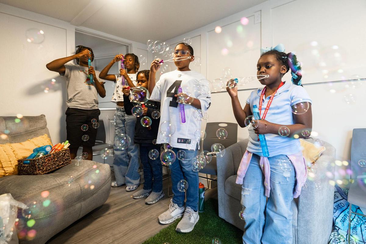 Children in the CHAMP program blow bubbles during a group therapy session at Rise Community Center in Fort Worth.