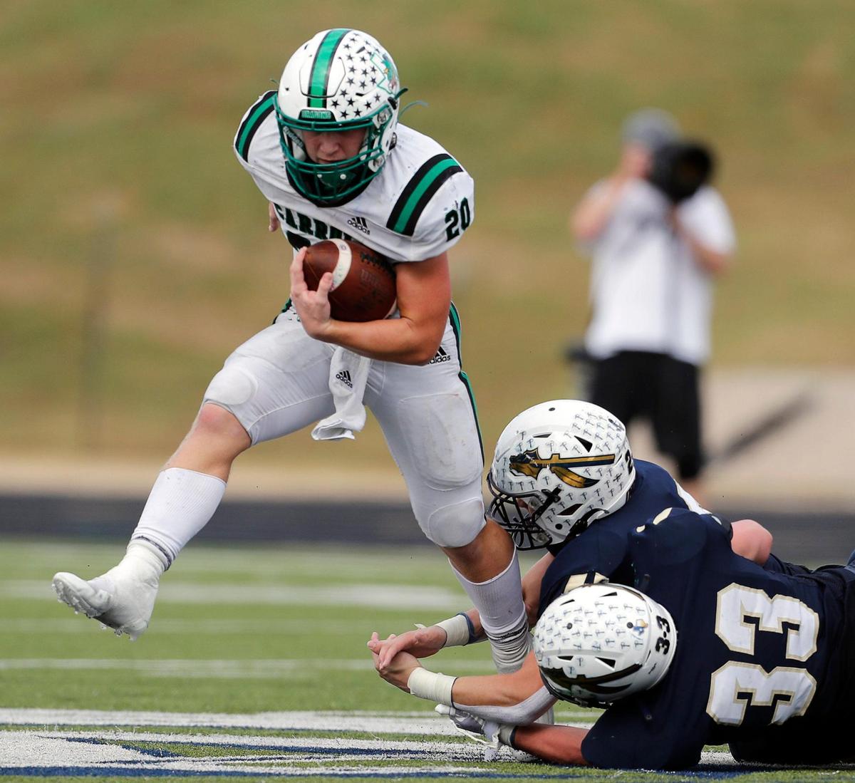 Carroll’s James Lehman (20) side steps Keller’s defense including linebacker Treyce Peck (33) during a high school football game at Keller ISD Stadium in Keller, Texas, Friday Oct. 01, 2021. Carroll defeated Keller 49-13. (Special to the Star-Telegram Bob Booth)