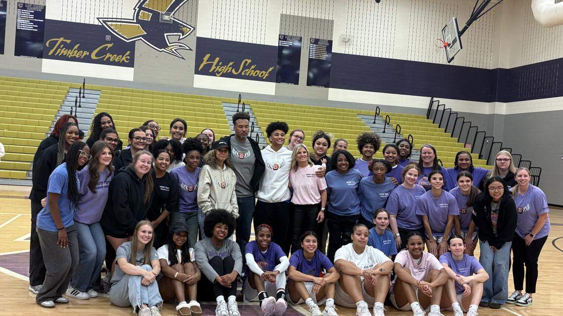 The Timber Creek High School girls’ basketball team poses for a photo with head coach Tina DeMichele and the family of Ava Moore, an alum of the team who was killed in a jet ski crash on Grapevine Lake in May.