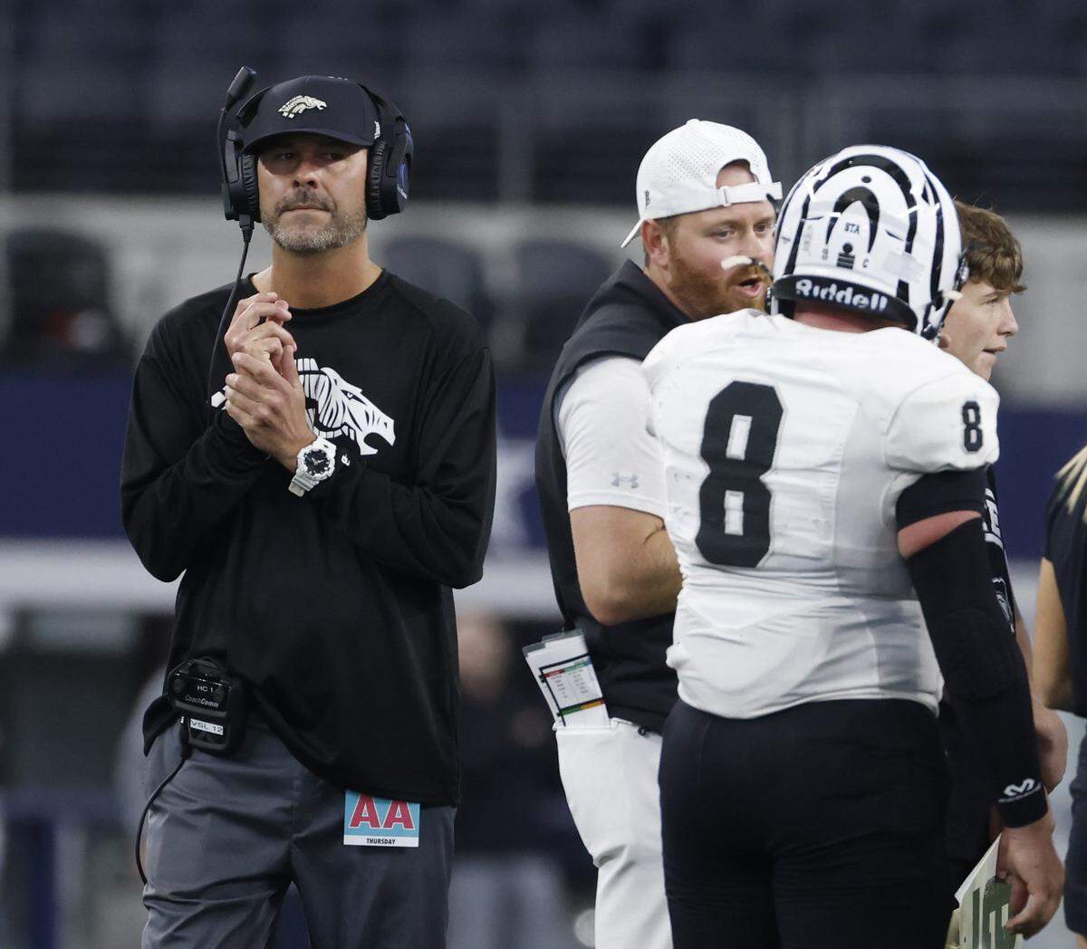 Grandview head coach Ryan Ebner wrings his hands as he circles the huddle during a timeout in the first half of a UIL Class 3A Division I championship game on Thursday Dec. 18, 2025 at AT&T Stadium in Arlington, Texas.