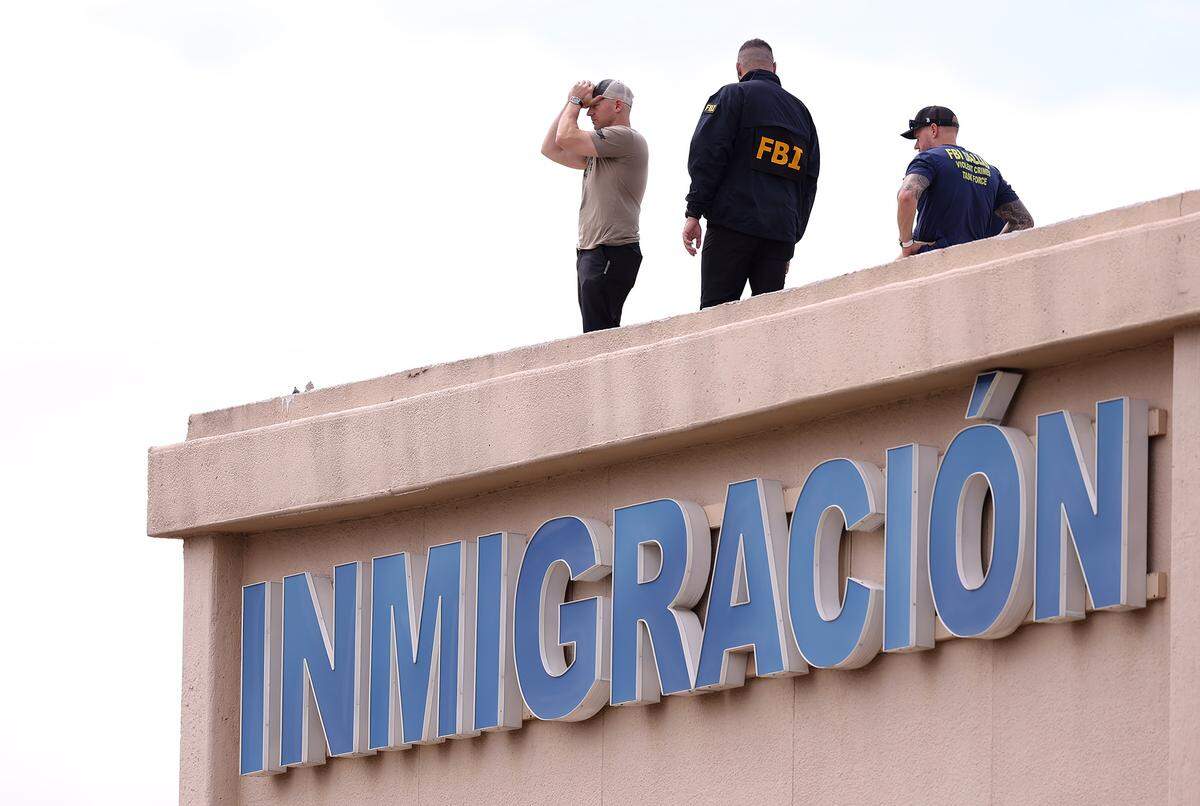 FBI agents investigate the scene where a shooting at an Immigration and Customs Enforcement facility occurred in Dallas on Wednesday, Sept. 24, 2025.