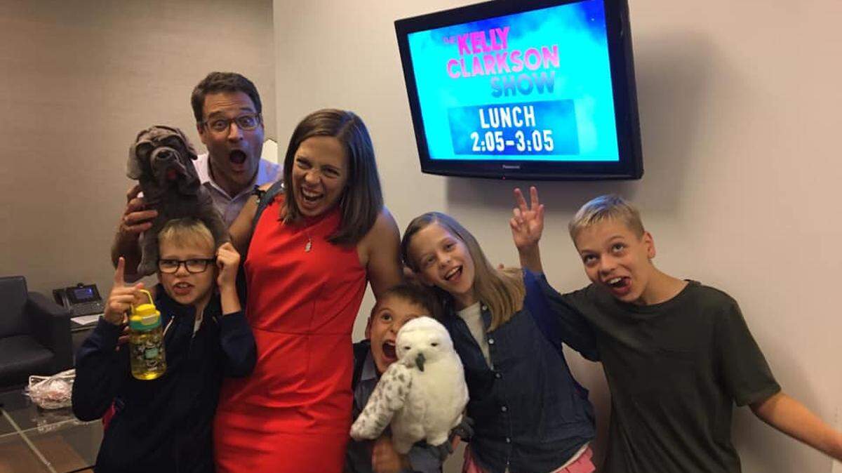 The Droege family, Brian, dad (in back); Clark, 9; Diana, mom; Dax, 7; Penelope, 10; and Edmund, 11, have fun in the green room awaiting their appearance on The Kelly Clarkson Show to discuss a neighborhood library they started in their garage.