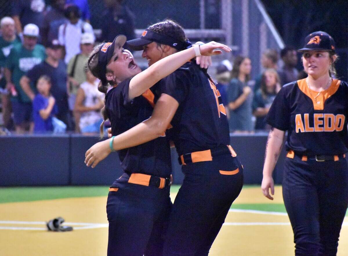 Aledo first baseman Brooklyn Taloa, right, hugs a teammate after a state semifinal berth at Birdville High School on Friday, May 16, 2025.