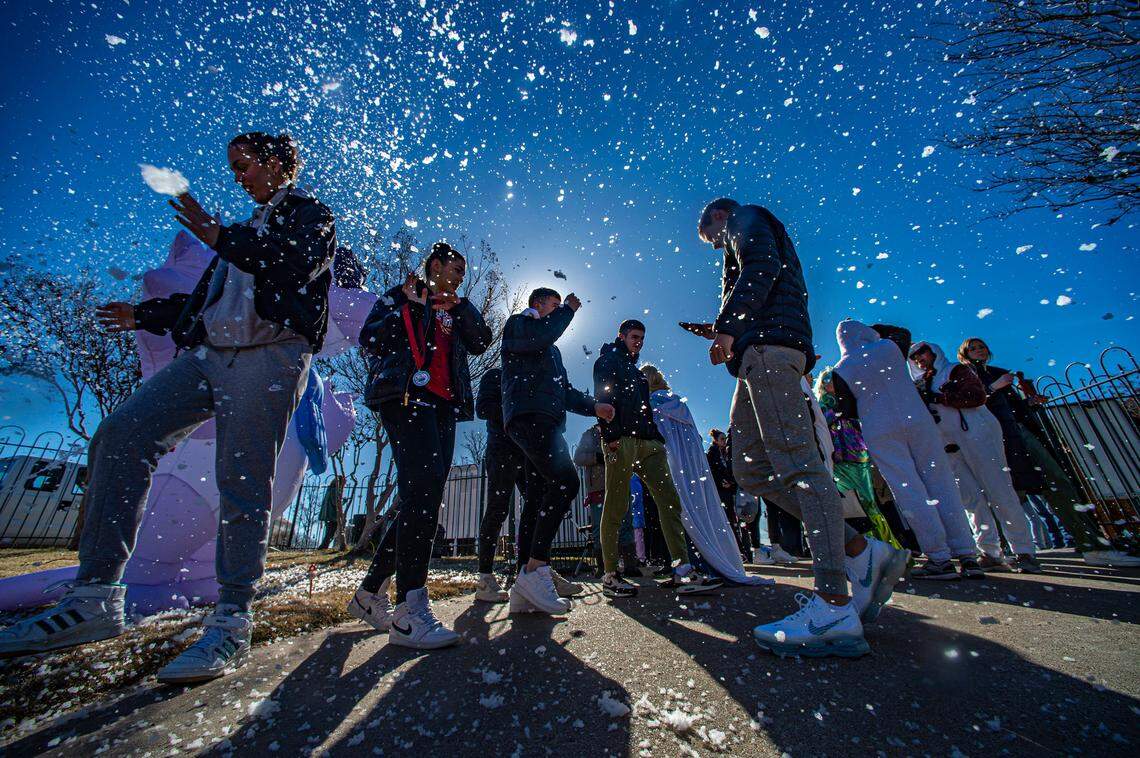 Snow flurries fall on participants of the Goosebump Jump in Granbury, Texas, Saturday, Jan. 20, 2024. Temperatures lakeside was in the 20s and the water temperature was 51 degrees.