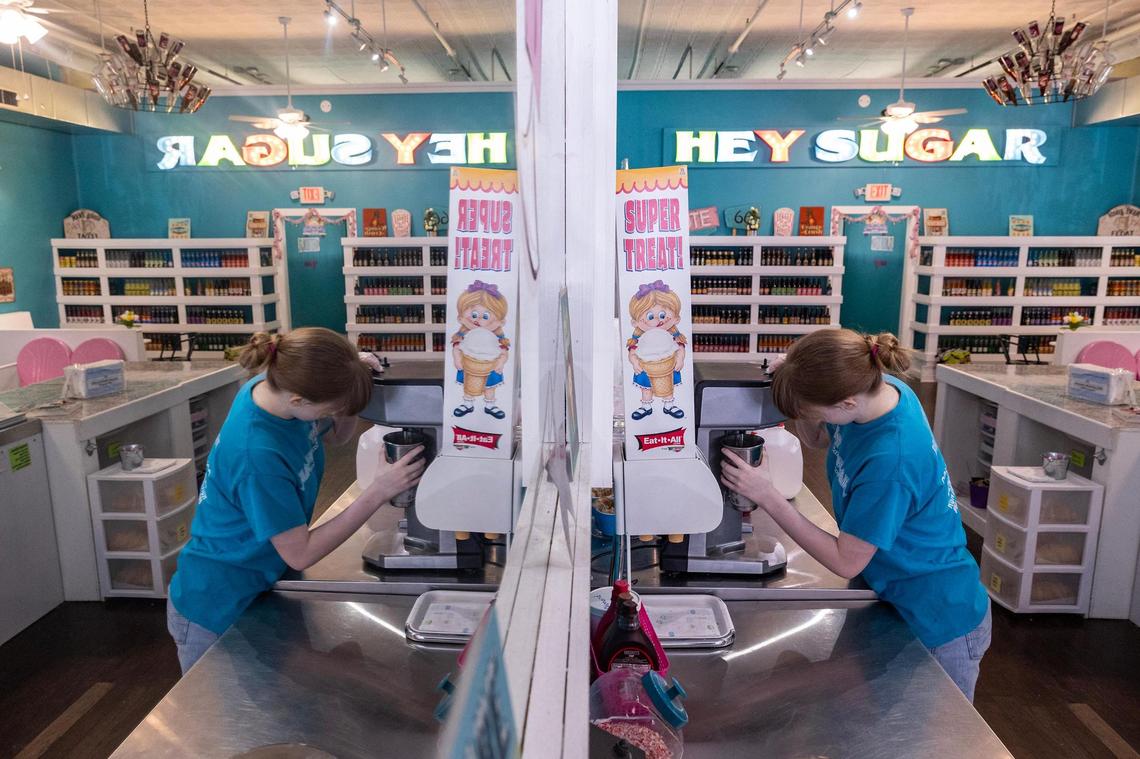 Employee Tyson Thompson, 17, makes a milkshake for a customer at Hey Sugar Candy Store in Decatur’s town square on Thursday, March 29, 2025. Thompson has lived in Decatur all her life and believes the city could use a makeover. She hopes the growth and development could jump-start that.