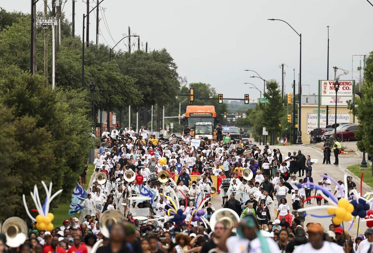 People walk down Montgomery Street for the Opal Lee Walk for Freedom on Friday, June 19, 2026, in Fort Worth. The walk, which started in 2016, was held to lobby for making Juneteenth a recognized national holiday.