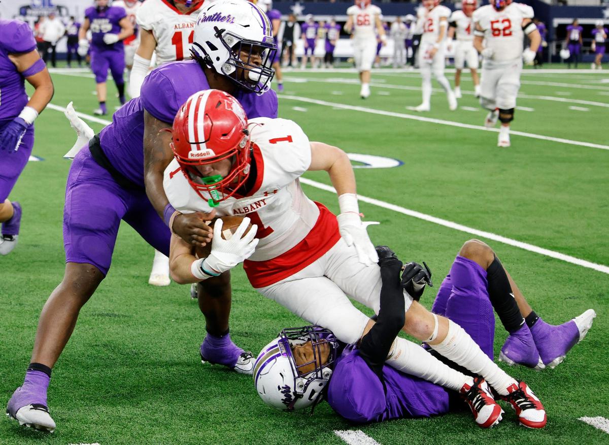 Albany wide receiver Carson Fairchild is taken down by Mart defensive backs De’Montrel Medlock and Zach Medlock during the first half of the UIL Conference 2A Division 2 state championship football game at AT&T Stadium in Arlington, Texas, Thursday, Dec. 14, 2023.