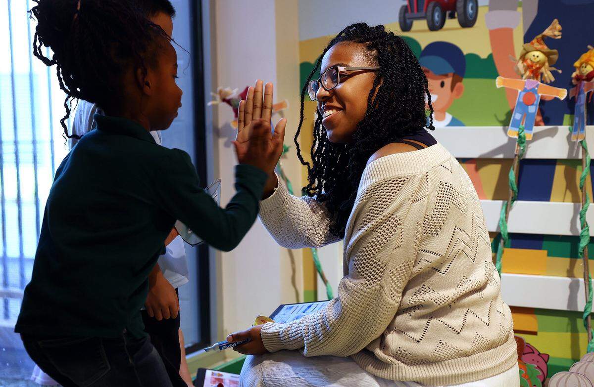 Tabitha Rice, 17, a senior at Ben Barber Innovation Academy, high-fives a pre-K student while interning at Jandrucko Early Learners Academy on Thursday, Nov. 6, 2025.