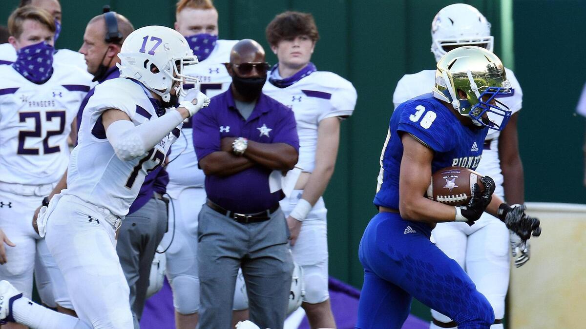 Chisholm Trail’s Bryce Hollingsworth left chases Boswell’s Ezra Carter as he takes in inteception in for the touchdown to take a 16-6 lead in the second quarter of their District 3-6A football game Saturday, November 7, 2020 at Globe Life Park in Arlington, Texas. Special/Bob Haynes