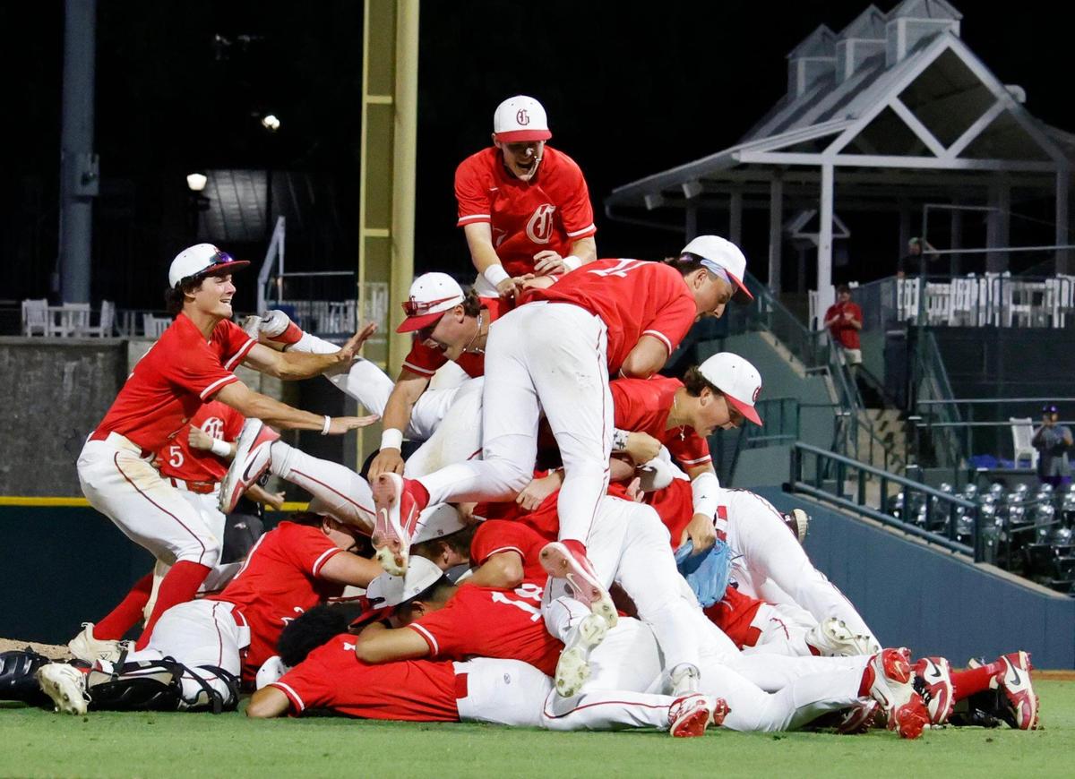 Somewhere in the bottom of the pile is Grapevine pitcher Sam DuRard (13) after winning a UIL 5A D2 semifinal baseball game at Riders Park in Frisco, Texas, Friday, May 30, 2025.