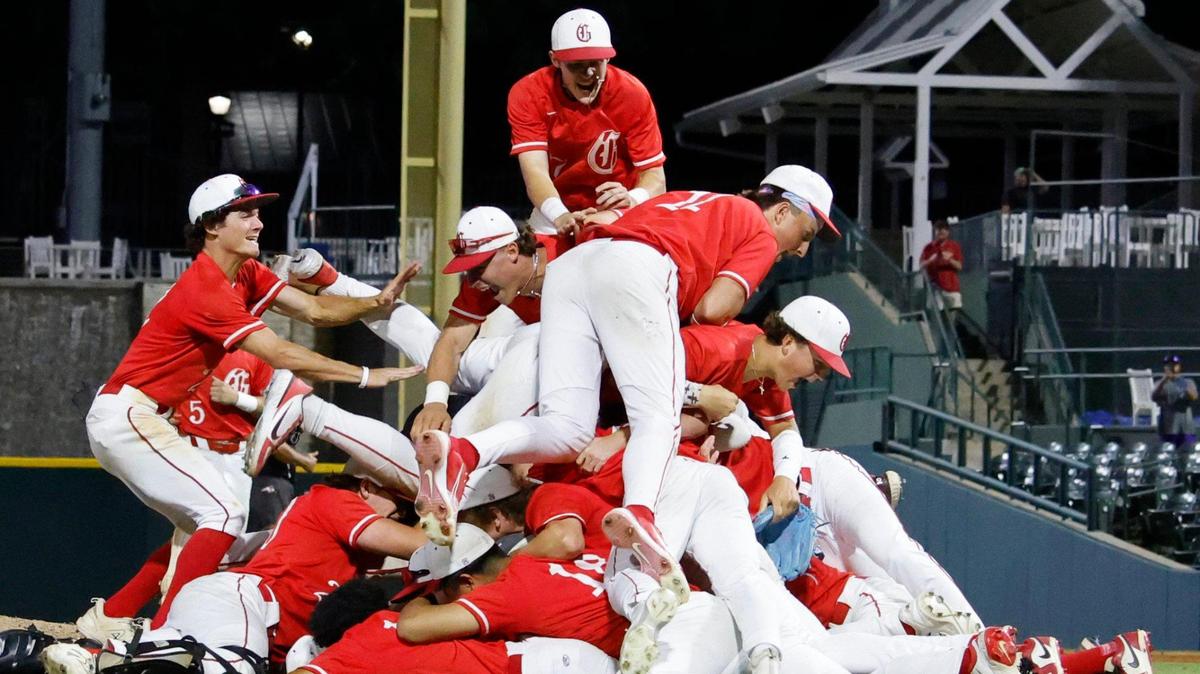 Somewhere in the bottom of the pile is Grapevine pitcher Sam DuRard (13) after winning a UIL 5A D2 semifinal baseball game at Riders Park in Frisco, Texas, Friday, May 30, 2025.