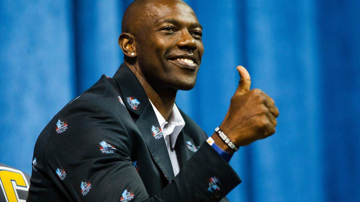 Terrell Owens wears a suit covered in Pro Football Hall of Fame logos at his ceremony Saturday. MUST CREDIT: Photo for The Washington Post by Kevin D. Liles