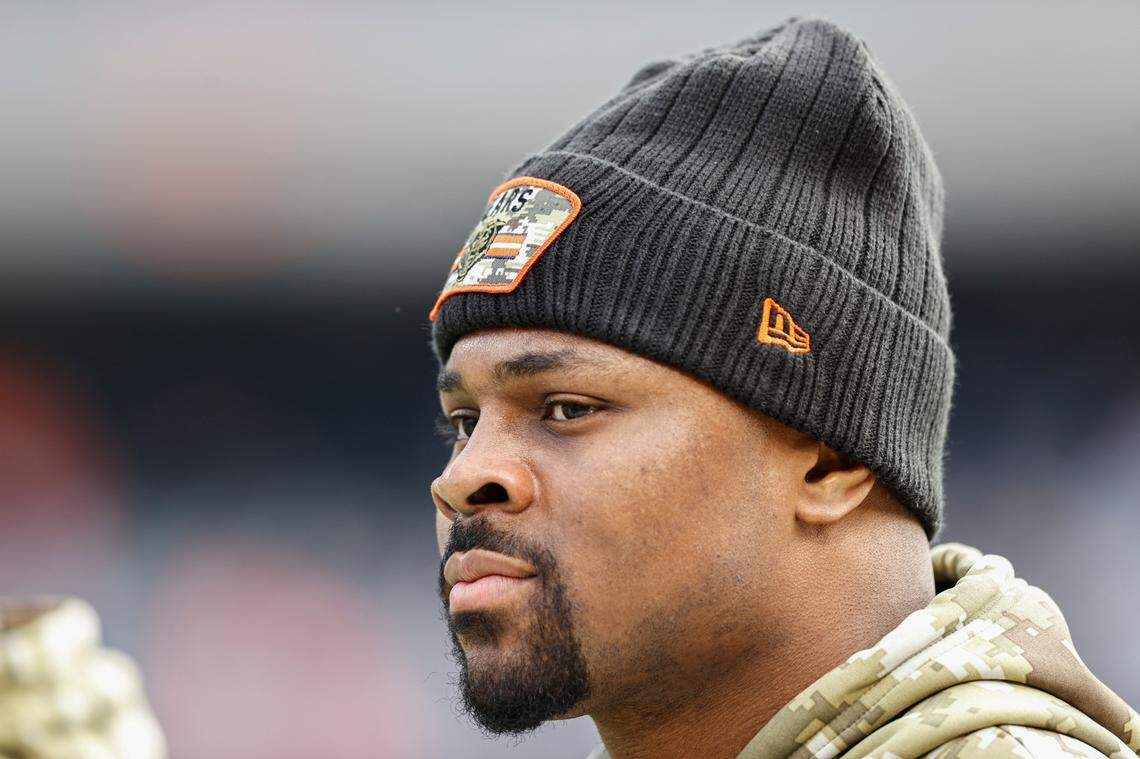 Injured Chicago Bears outside linebacker Khalil Mack (52) walks on the sidelines during warms up prior to an NFL football game against the Baltimore Ravens, Sunday, Nov. 21, 2021, in Chicago. (AP Photo/Kamil Krzaczynski)