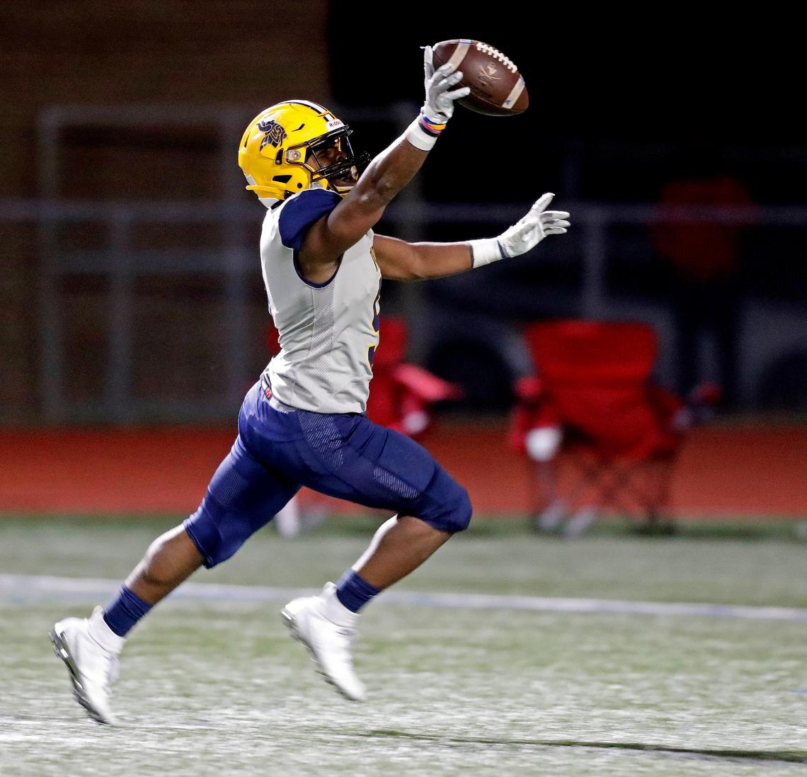 Lamar inside linebacker Jayveion Moore (9) shows off his interception as he crosses the goal line to put the game out of reach during the second half of a high school football game at Wilemon Field in Arlington, Texas, Friday, Nov. 01, 2019. The Lamar Vikings defeated the Bowie Volunteers 32-17. (Special to the Star-Telegram Bob Booth)