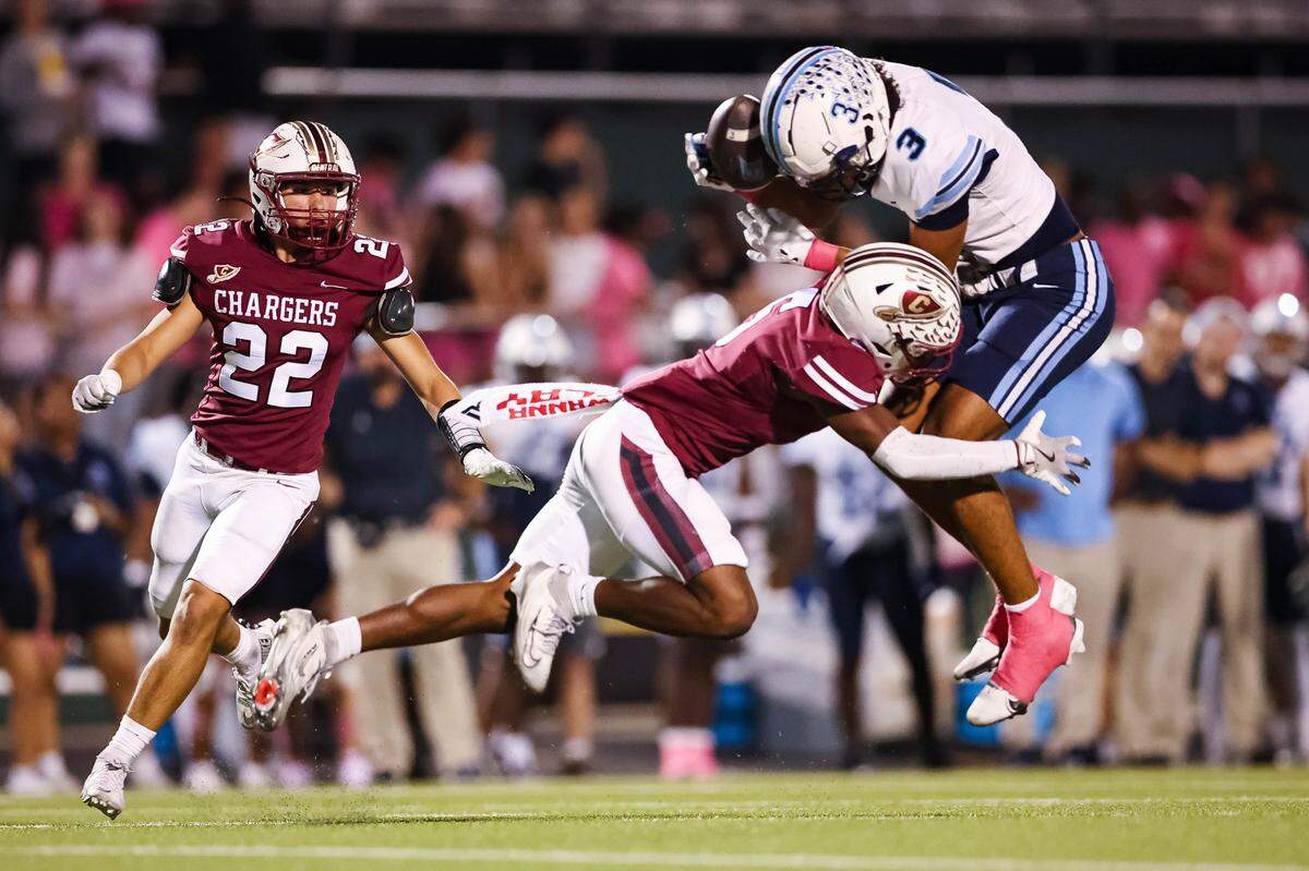 L.D Bell wide receiver Braelon Solomon is tackled by a Keller Central defensive back after making a catch during a district game between Keller Central and L.D. Bell at Keller ISD Stadium in Keller, Texas on October 16, 2025.
