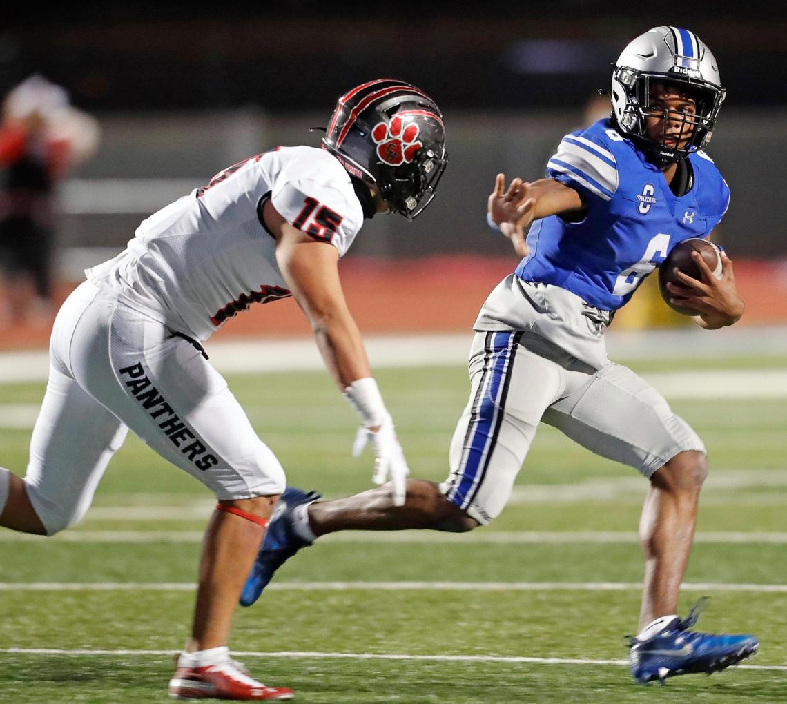 Burleson Centennial quarterback Phillip Hamilton (6) attempts to avoid the tackle of Colleyville Heritage linebacker Chris Knight (15) during a 5A high school football game at Burleson ISD Stadium in Burleson , Texas, Friday, Nov. 27, 2020. Colleyville led 17-0 at the half. (Special to the Star-Telegram Bob Booth)