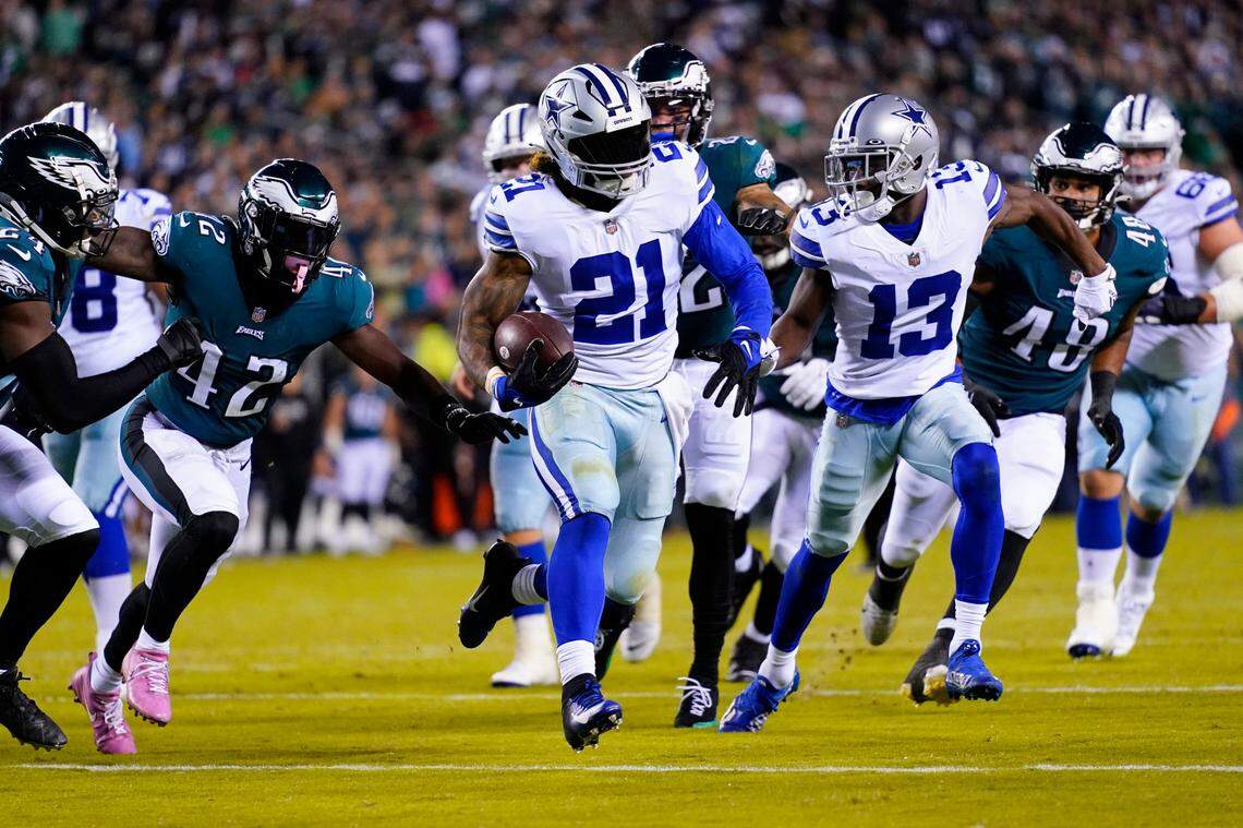 Dallas Cowboys’ Ezekiel Elliott, center, runs for a touchdown during the second half of an NFL football game against the Philadelphia Eagles on Sunday, Oct. 16, 2022, in Philadelphia. (AP Photo/Matt Rourke)