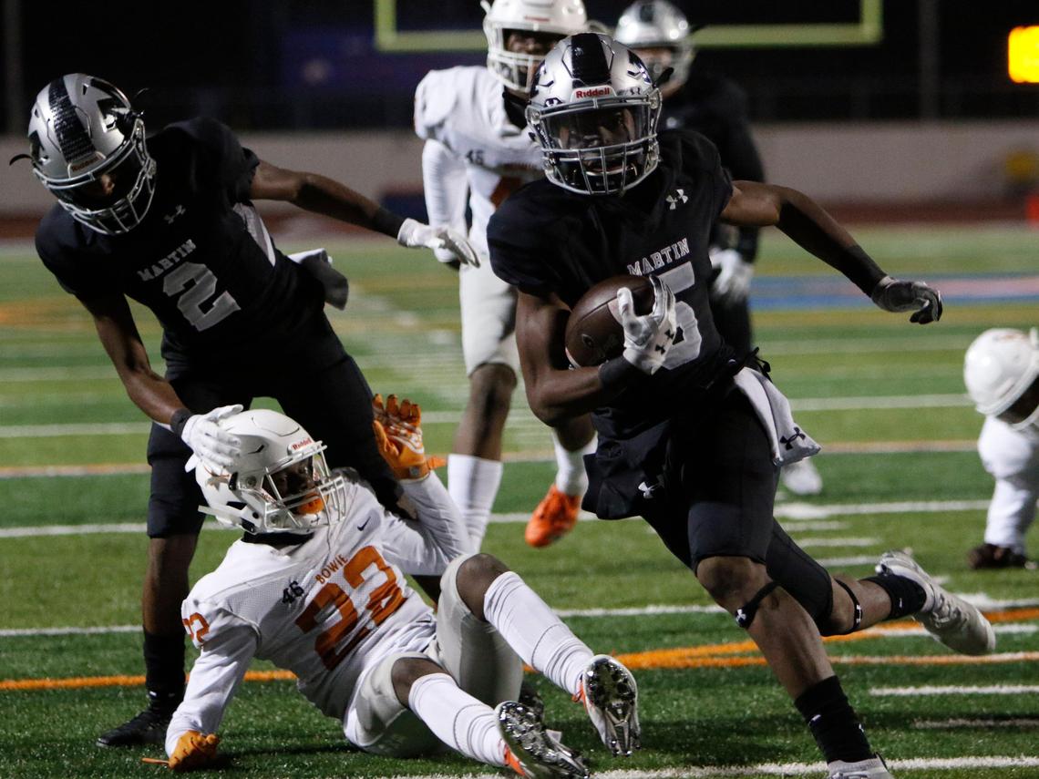 Martin’s Lenard Lemons (5) gets past Bowie’s Tre Martin (22) for a touchdown during the first half of a high school football game at Maverick Stadium in Arlington, Texas, Thursday, Nov. 7, 2019.