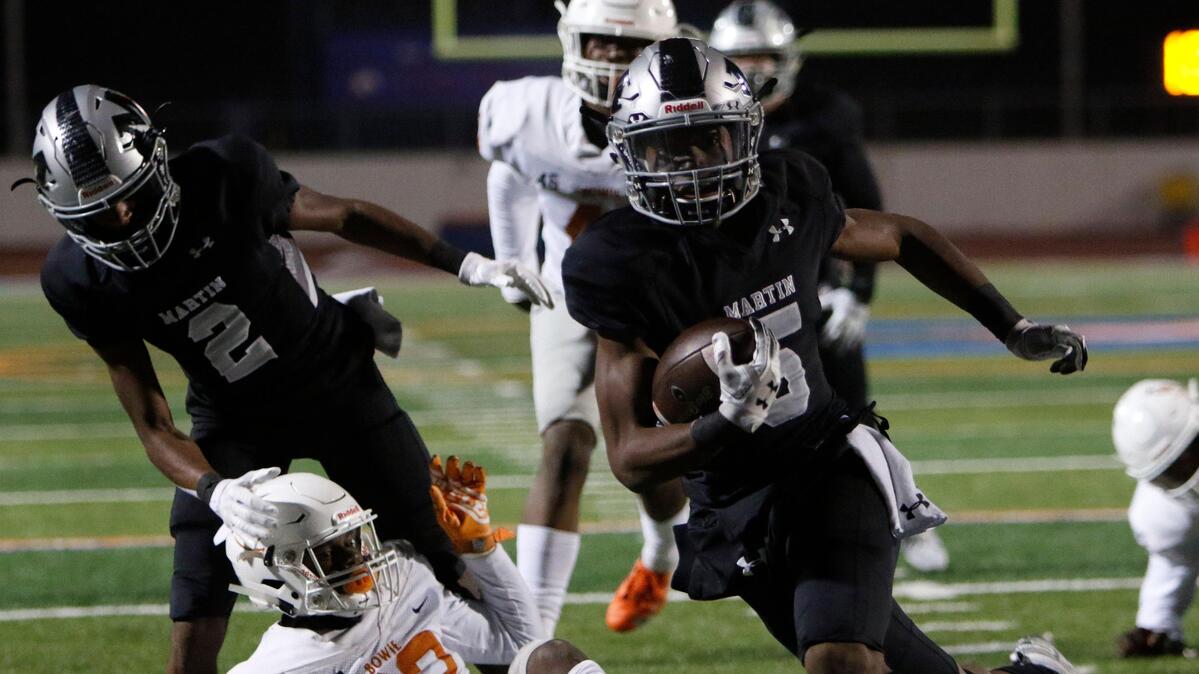 Martin’s Lenard Lemons (5) gets past Bowie’s Tre Martin (22) for a touchdown during the first half of a high school football game at Maverick Stadium in Arlington, Texas, Thursday, Nov. 7, 2019.