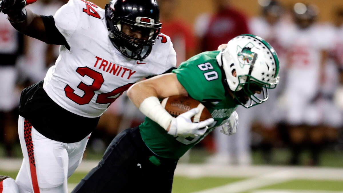 Trinity linebacker Max Sagako (34) closes in on Southlake wide receiver John Manero (80) after he jumps over defensive back Micah Woodley (31) in the first half of a high school 6A Division I Regional Round football playoff game at Apogee Stadium in Denton, Texas, Friday, Nov. 30, 2018. Carroll led 21-7 at the half. (Star-Telegram Bob Booth)

