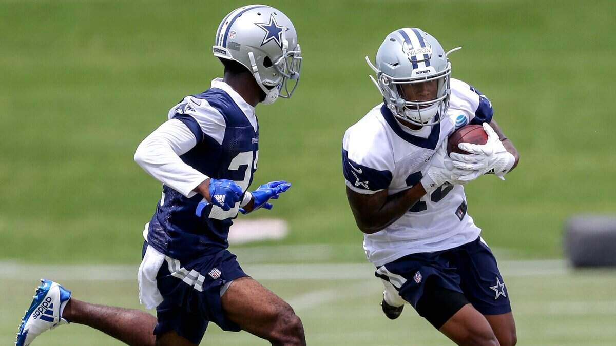 Cowboys rookie wide receiver Cedrick Wilson, right, tries to get past cornerback Jourdan Lewis during mini camp practice in June. Wilson injured a shoulder in Saturday’s first padded practice at training camp in Oxnard, Calif., and his status is unknown.
